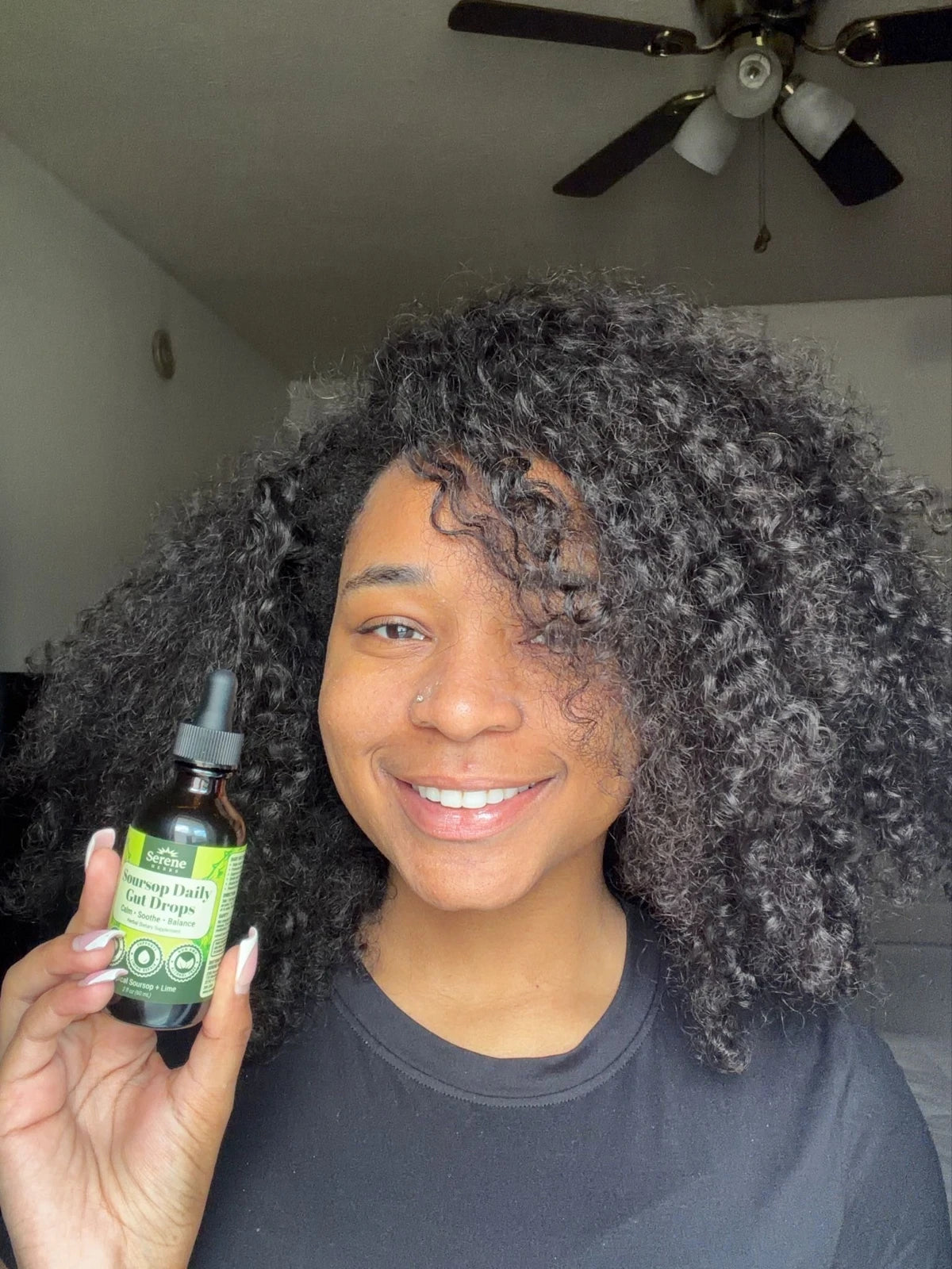 Customer holding Soursop Daily Gut Drops