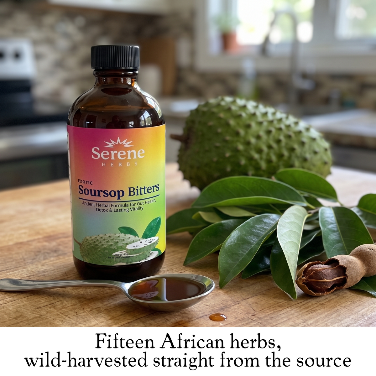Soursop Bitters bottle beside a tablespoon of the liquid, fresh soursop leaves and a whole soursop fruit